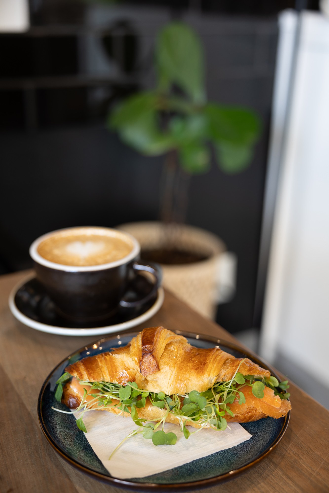 Coffee and a plated breakfast on a café table