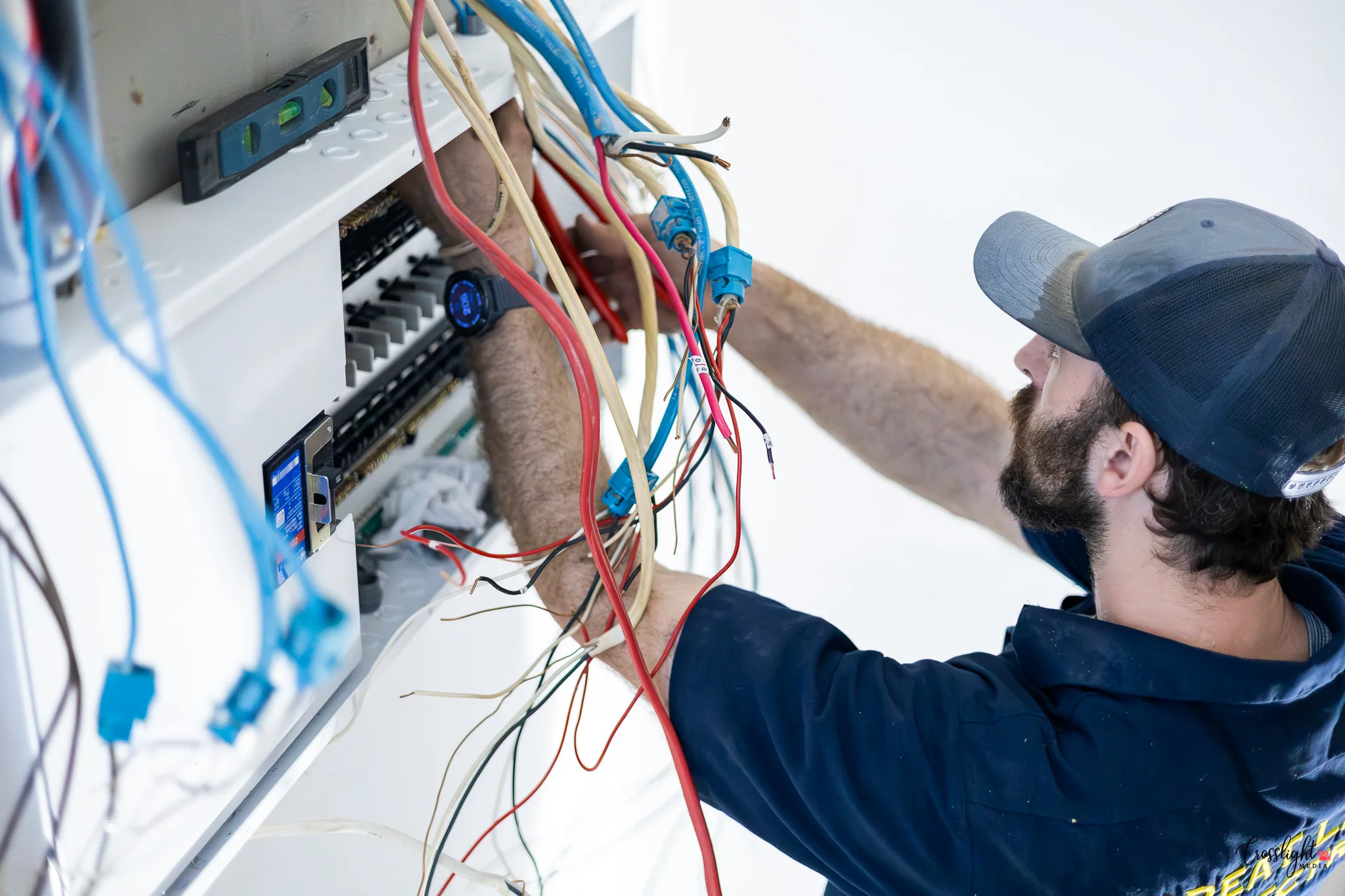 Electrician completing detailed work during a business brand session