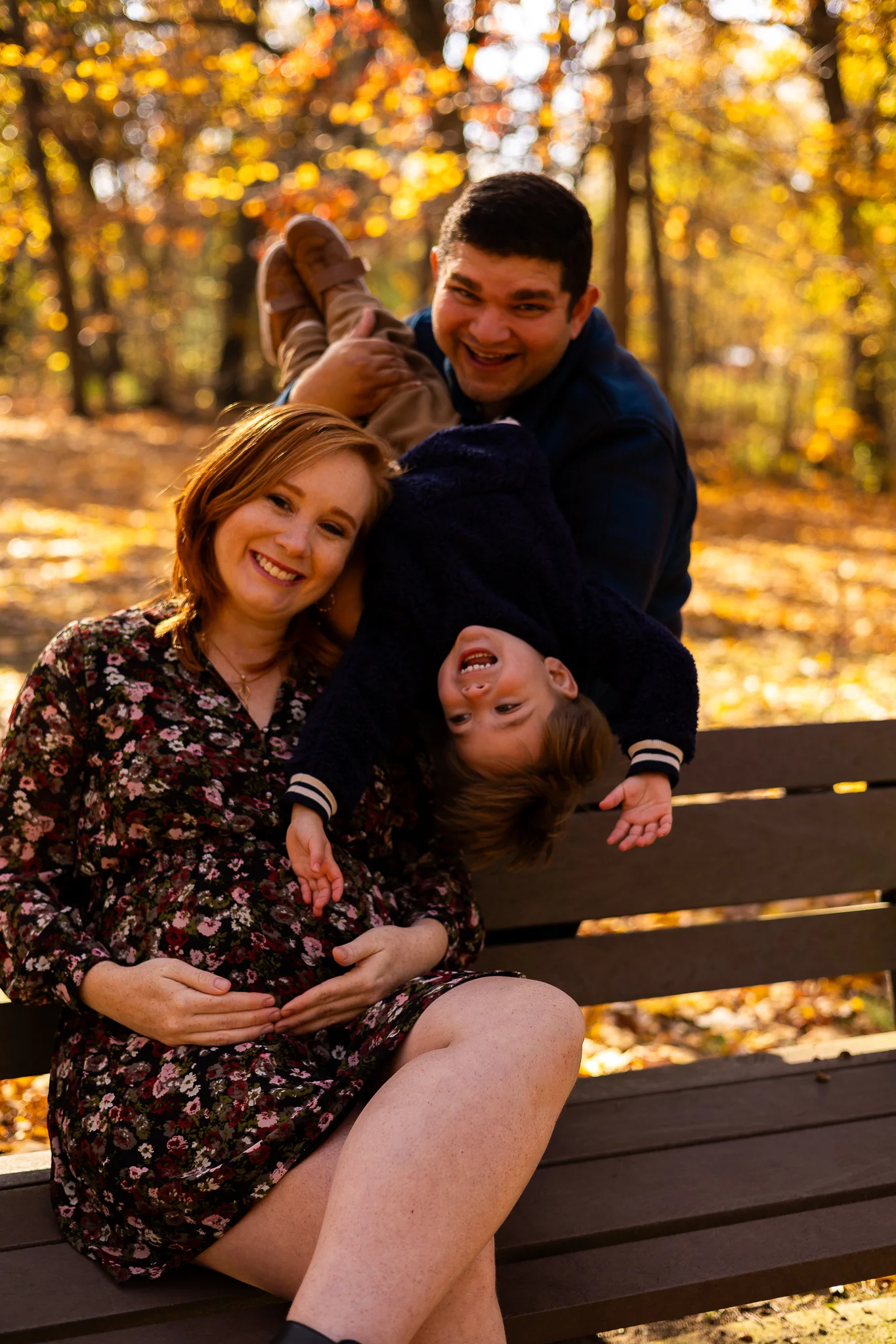 Mother laughing with her child during an autumn family session