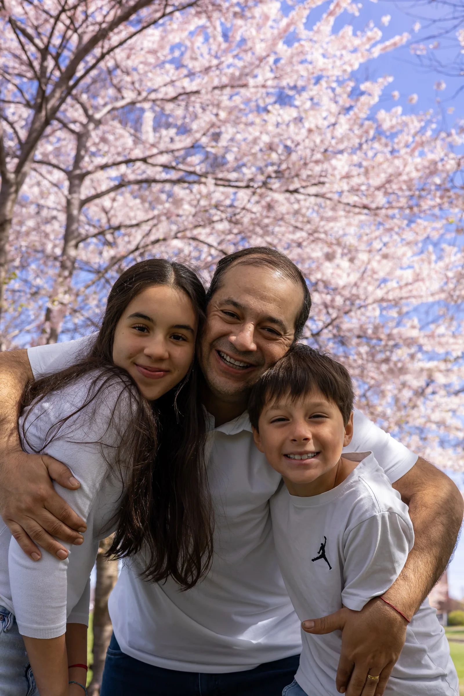 Father embracing his children during a spring family session