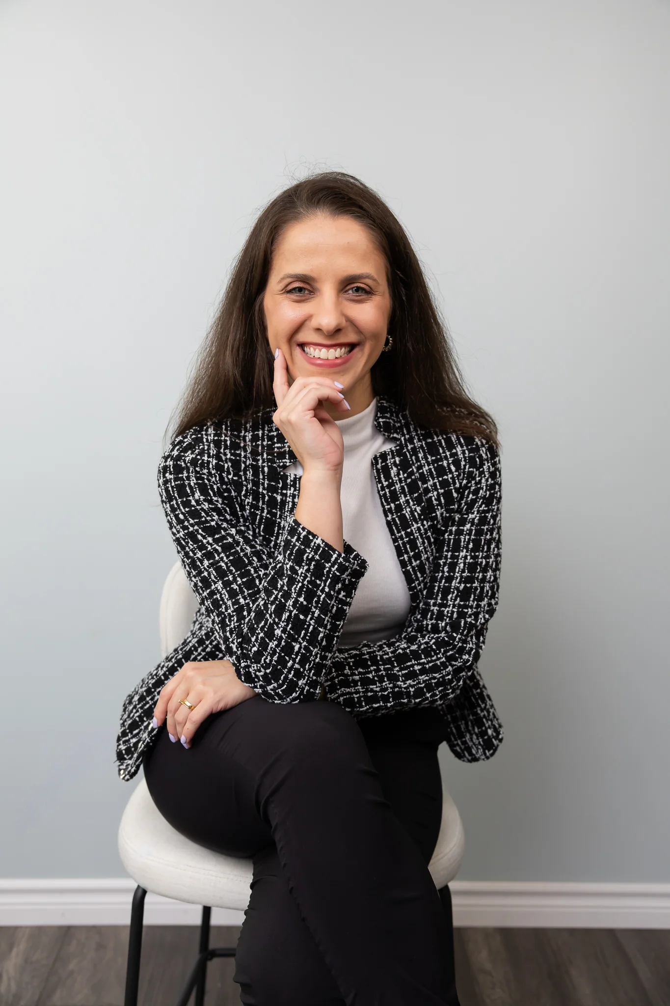 Confident professional portrait of a woman in a black jacket